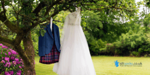 Kilt and wedding dress hanging from a tree branch