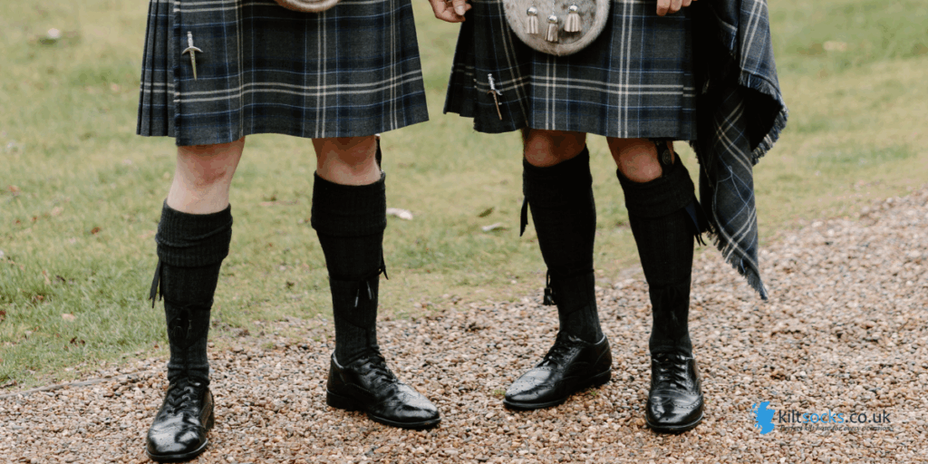 black kilt socks worn by two men in kilts