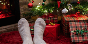 Kilt socks and tartan pajamas near a Christmas tree