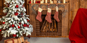 Kilt socks hanging from a mantlepiece near a Christmas tree