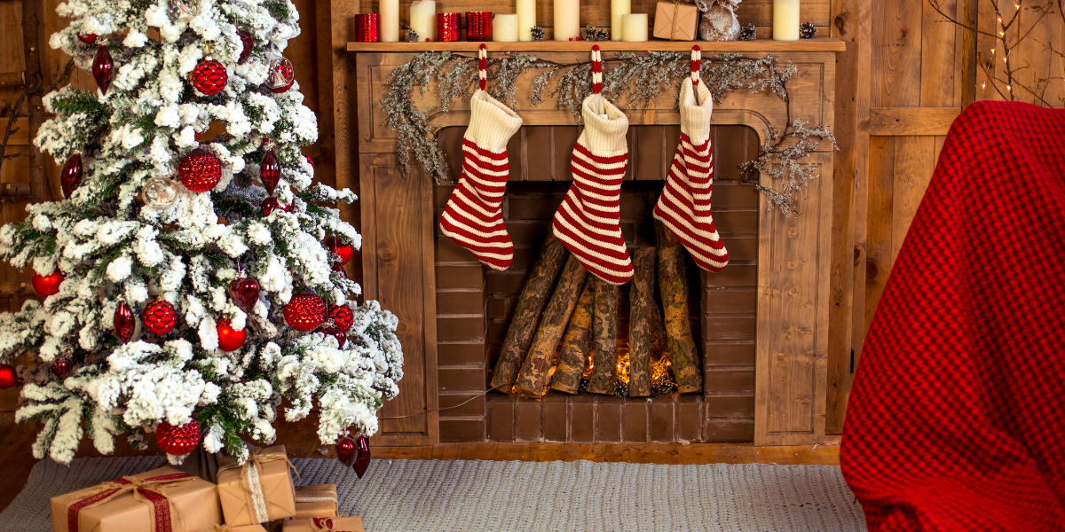 Kilt socks hanging from a mantlepiece near a Christmas tree